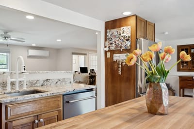 A kitchen area with flowers on the counter