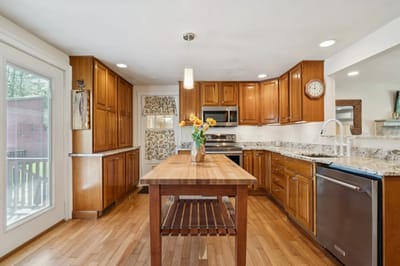 Bright kitchen space with wooden cabinets and a table.