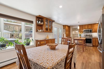Cozy dining area with wooden furniture and window view.