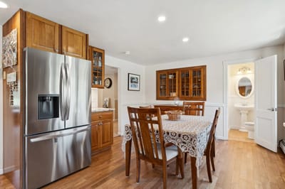 Interior view of a dining area with a kitchen.
