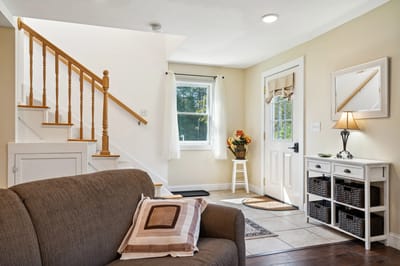 Cozy common area with stairs and natural light.
