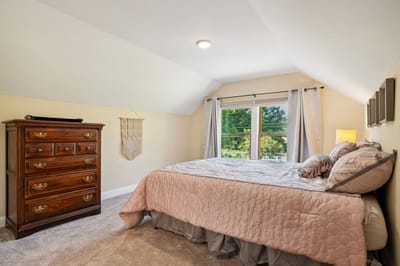 Cozy bedroom with natural light and furnishings.