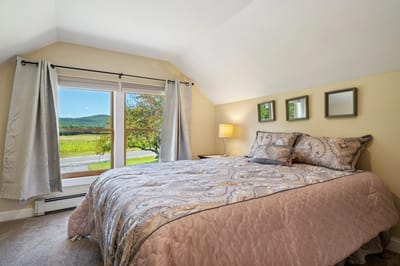 Cozy bedroom with a view of nature.