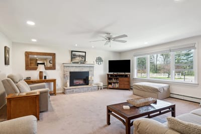 Cozy living room with comfortable seating and a fireplace.