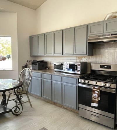 Modern kitchen area with appliances and table
