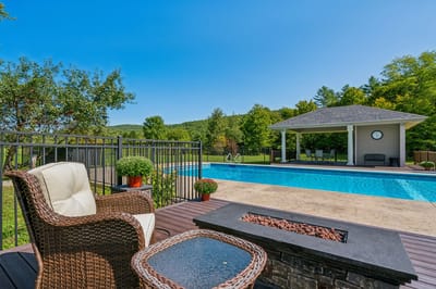 Outdoor pool area with lounge chairs and gazebo