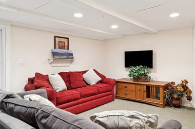 Cozy common area with a red couch and decor.