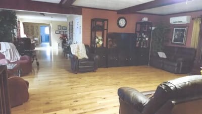 Common area with seating and wooden floors.