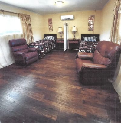Cozy interior of a resident room with two beds.