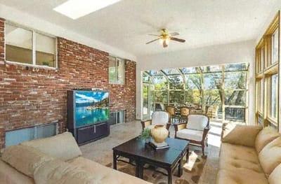 Bright living area with comfortable seating and large windows.