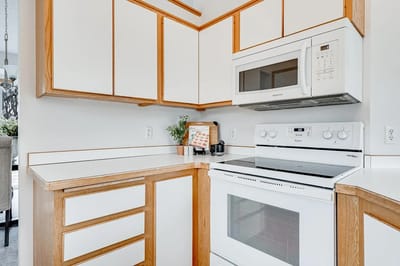 Modern kitchen interior with white cabinets and appliances