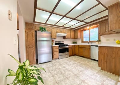 Bright kitchen area with wooden cabinets and appliances