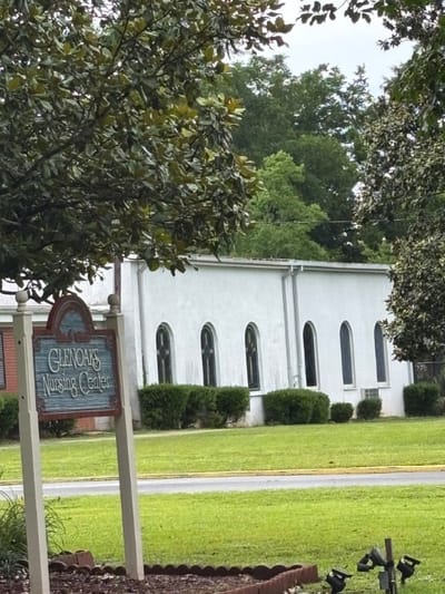 Exterior view of Glen Oaks Nursing Center with signage