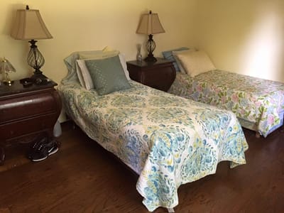Private resident room with two beds and lamps