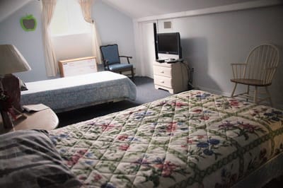 Cozy bedroom in a senior care facility with a floral quilt