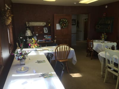 Cozy dining area set for a meal with flowers