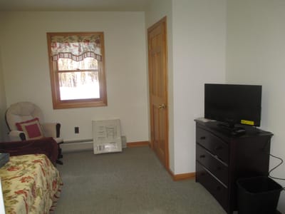 Cozy interior room with a bed and TV