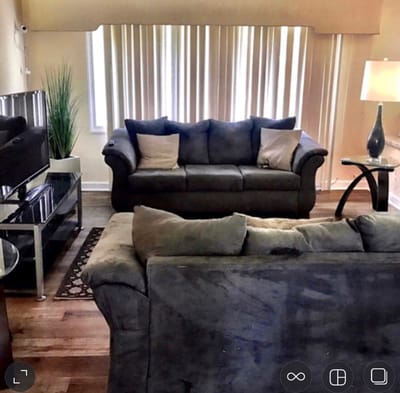 Living room with couches and light curtains
