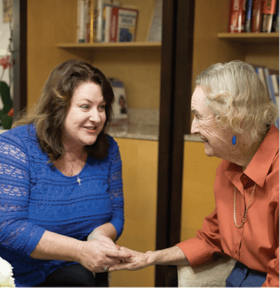 Staff member engaging with a resident in a warm setting