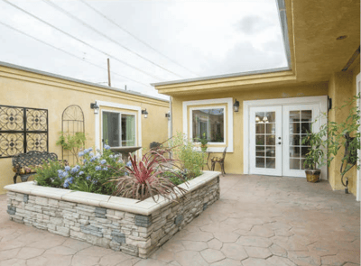 Outdoor courtyard with plants and seating area