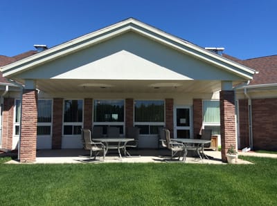 Outdoor seating area with tables in front of the facility