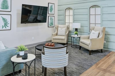 Bright common area with comfortable seating and plants