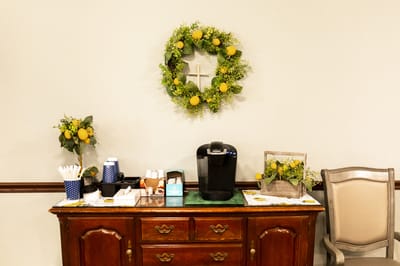 Decorative coffee station in a common area with a lemon theme