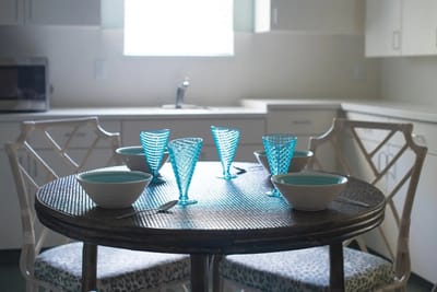Well-set dining table with blue glasses and bowls