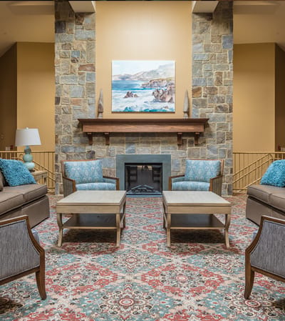 Bright common area with seating and a fireplace