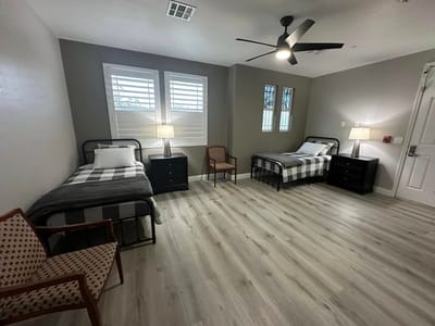 A shared resident room with two beds and decor