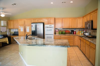 Bright kitchen area with fruits and appliances