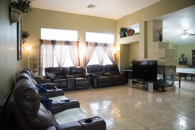 Common area with brown leather sofas and large windows