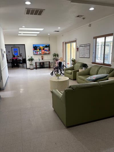 Interior of a common area with residents and seating