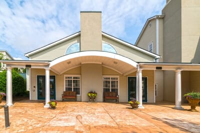 Exterior view of the facility entrance with seating
