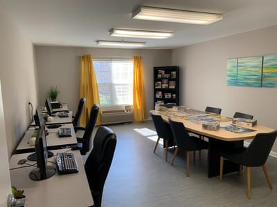 Bright common area with computers and puzzles