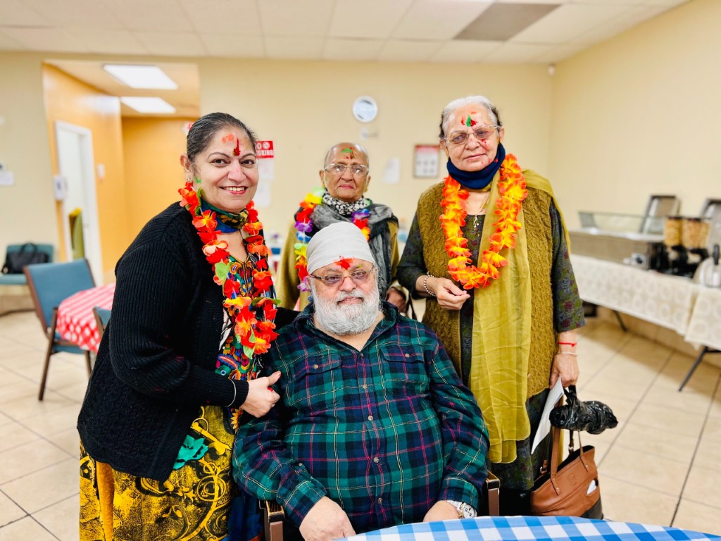 Residents celebrating with leis and smiles