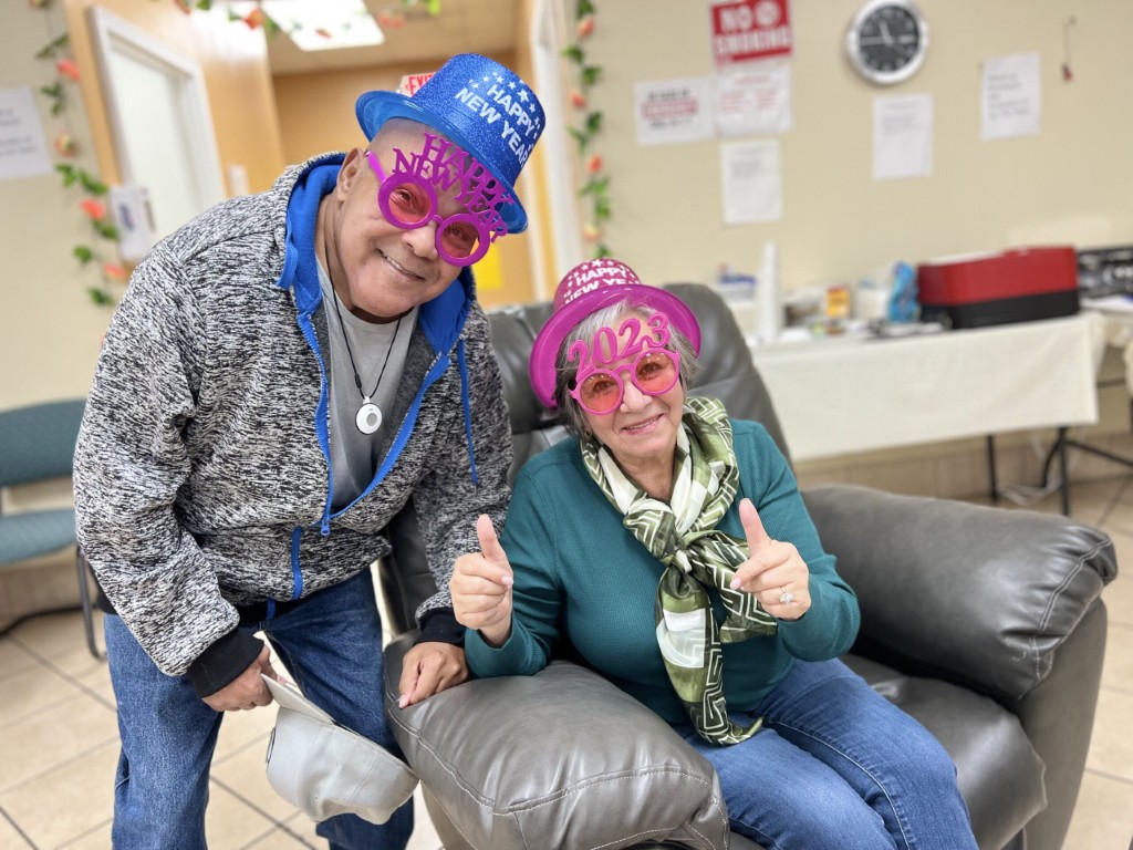Residents celebrating with party hats and glasses