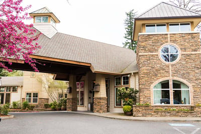 Exterior view of a senior living facility with landscaped entrance