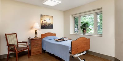 Comfortable resident room with bed and chair