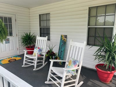 Quiet outdoor seating area with rocking chairs and plants