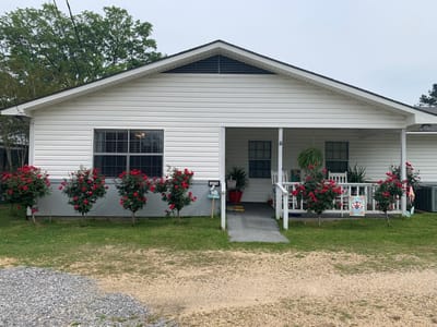 Exterior view of a senior living facility with flowers