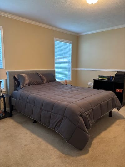 Cozy private resident room with a bed and desk