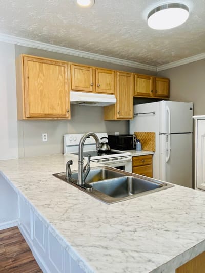 Modern kitchen with wooden cabinets and marble countertop