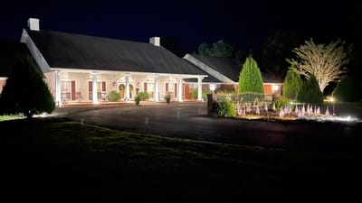 Exterior view of the facility at night with lighting