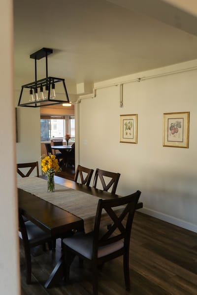 Bright dining room with a large table and flowers