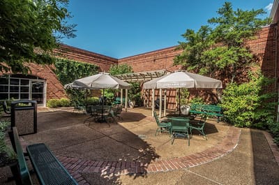 Outdoor seating area with tables and umbrellas