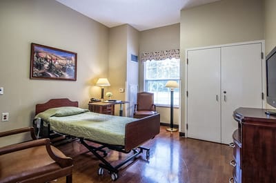 Cozy resident room with a bed and seating area