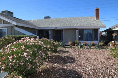 Exterior view of the facility with flowers and landscaping.