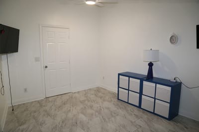 Bright, simple interior room with minimal furniture.