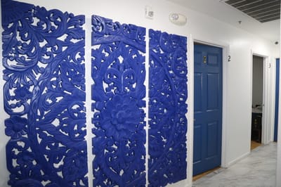 Interior hallway featuring decorative blue wall art.